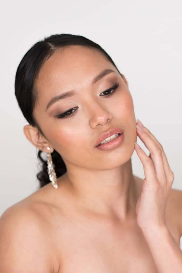 Asian mono lid eye makeup for wedding day nude lips bride wearing a sleek hairstyle for a wedding