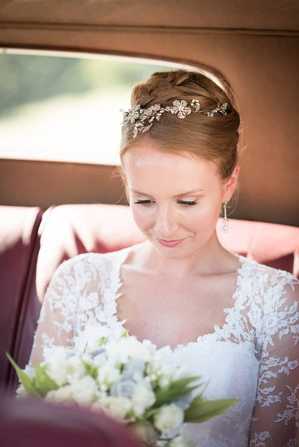 Bride sitting in a car wearing a natural bridal makeup