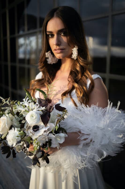 Bride wearing feather boa smokey eyes makeup for a wedding day