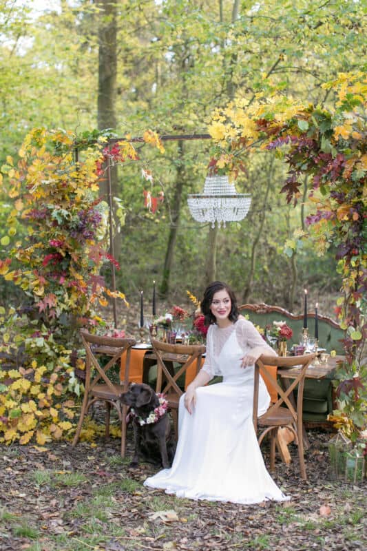 woodland wedding bride with her dog Autumnal wedding in countryside