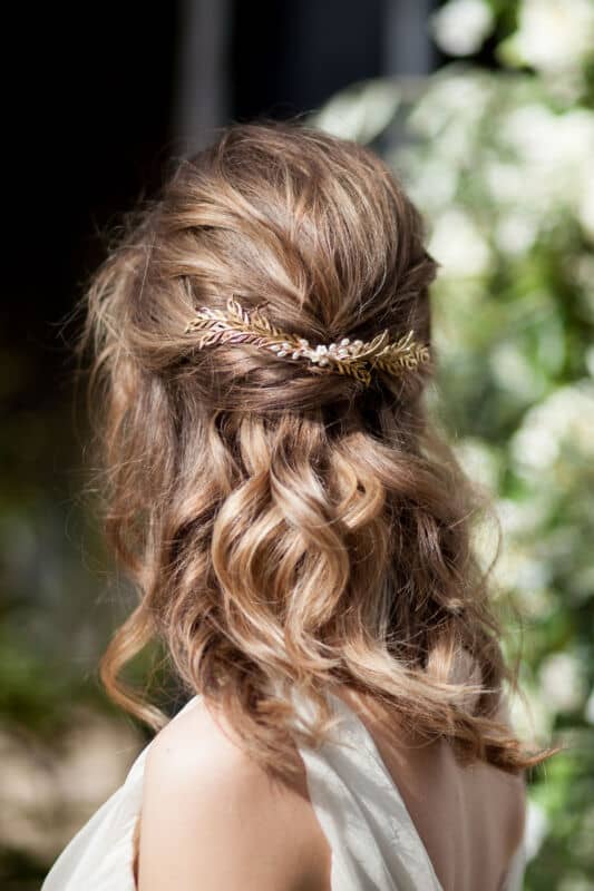 Romantic hair half up half down with gold leafy headpiece
