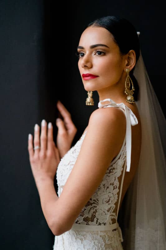 Flawless wedding makeup with red lips Brazilian beauty wearing gold earrings