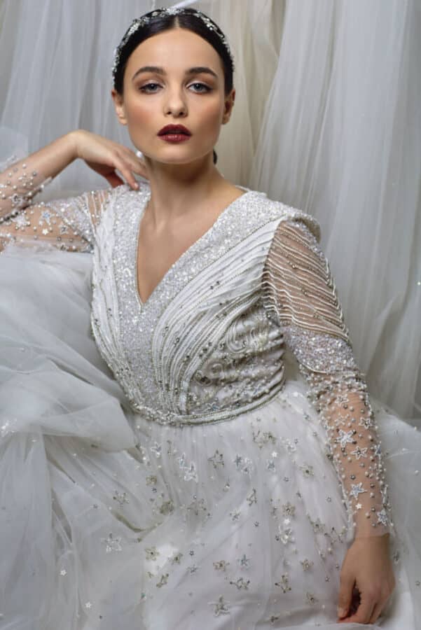 bridal makeup look with berry lips sleek bun for a wedding bride wearing long sleeve dress