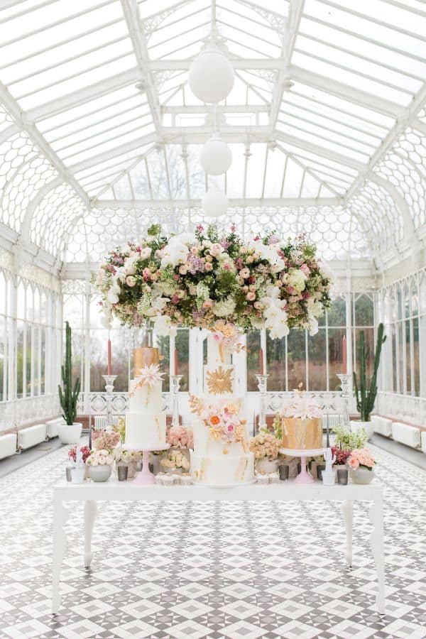 "wedding cake and floral installation in Horniman Museum and gardens Conservatory"